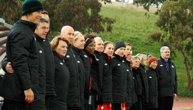 The Canadian team stands for the anthem