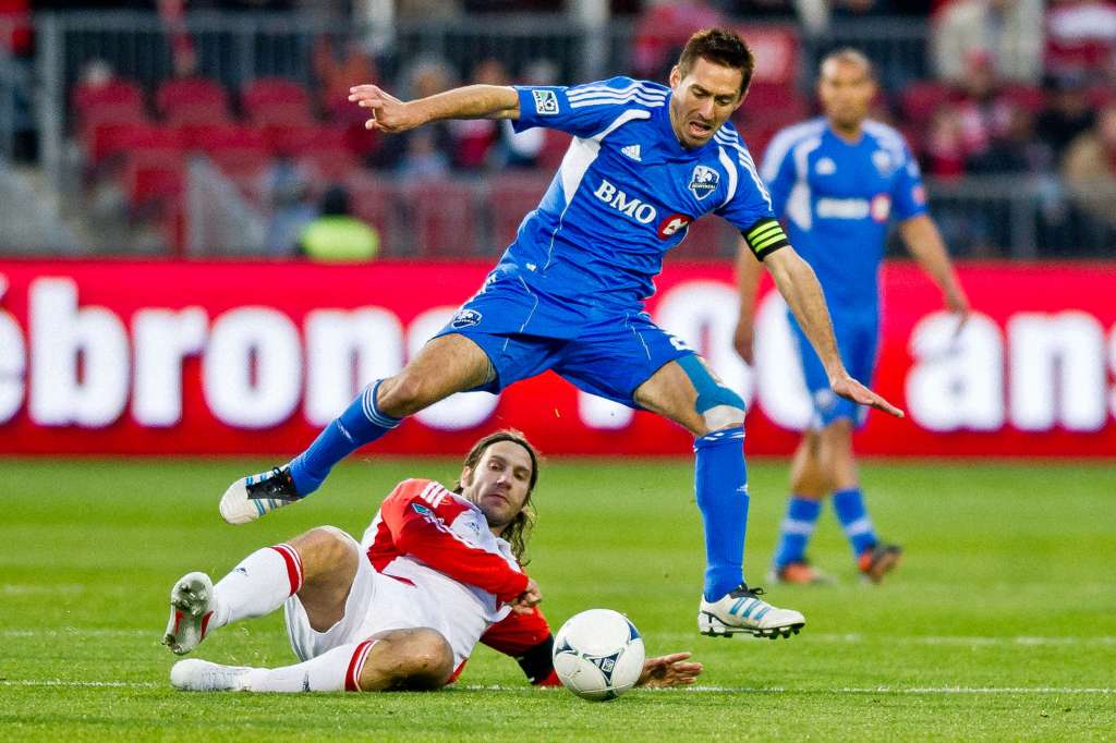 TFC's Torsten Frings tackles Montreal's Davy Arnaud. PHOTO: CANADA SOCCER