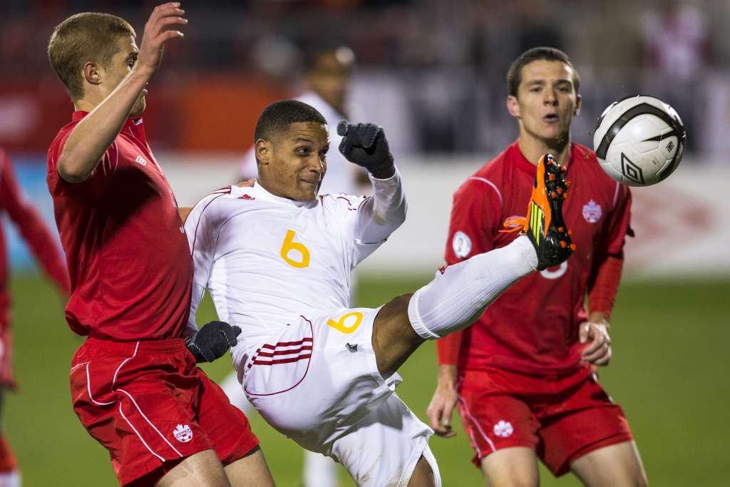 Cuba's Yoel Colome is tries to play the ball away from Canadians Andre Hainault, left, and Will Johnson. PHOTO: CANADA SOCCER/PAUL GIAMOU
