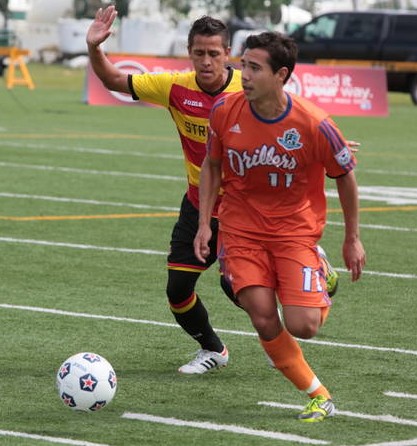 Matt Lam, in orange, takes control of the ball. PHOTO: TONY LEWIS/FC EDMONTON